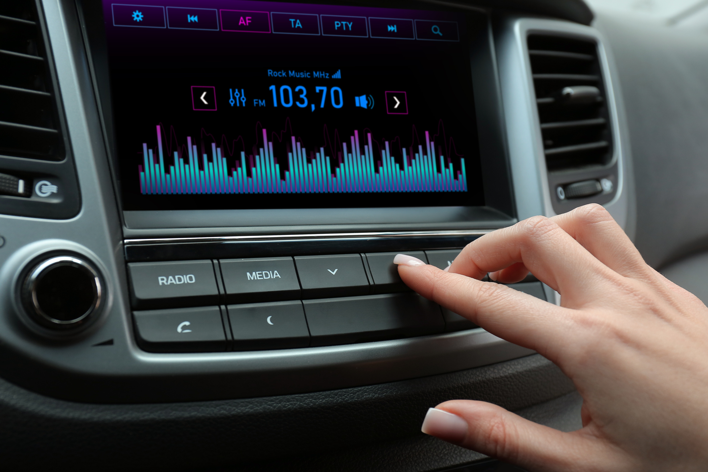 Woman Tuning into a Radio Station in Car